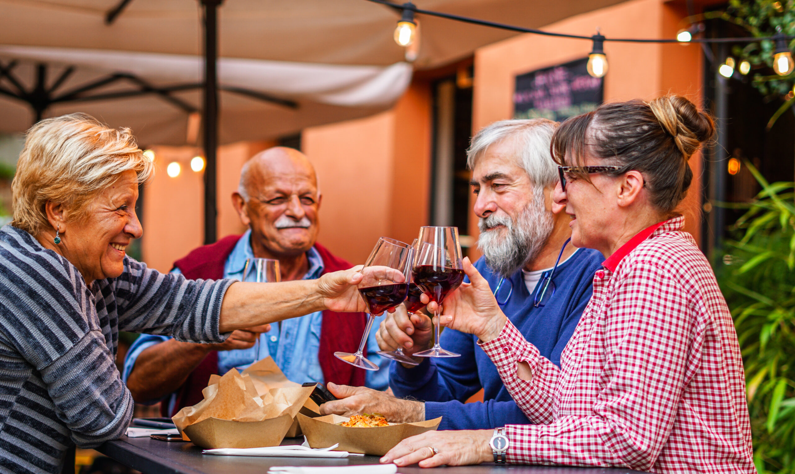 elderly couples eat and drink together